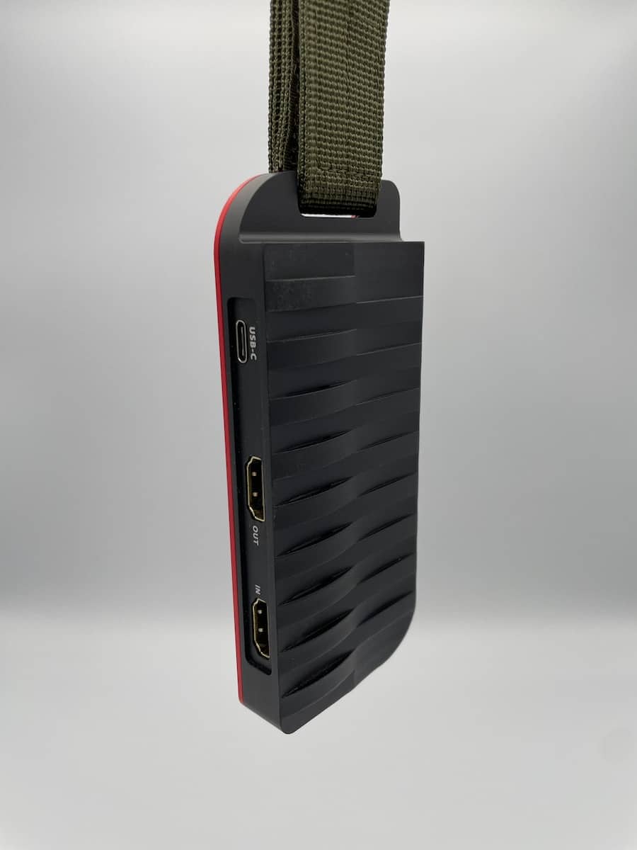 a black and red device hanging from a cord